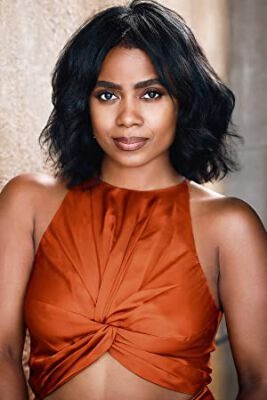 Picture of Serena Reeder by wearing orange dress.